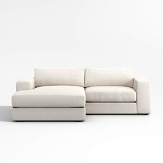 a white couch sitting on top of a white floor