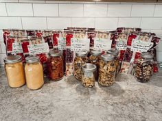 several jars filled with different types of food on a counter top next to each other