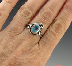 R945- Sterling Silver Ring with a 9 x 7 mm Faceted Oval Swiss Blue Topaz. Size 9. I can size it to fit, just contact me. No charge to size down, and no charge for one size up. Topaz is bezel set for a nice low profile ring. The top of the ring measures 17 mm and the band is 2 mm. This ring is made by the Lost wax Casting method, were I make the design in wax and then cast it into silver. To learn more about Me and the Lost Wax Method please visit my website at www.denimanddiamondjewelry.com Than Handmade Oval Topaz Ring For Formal Occasions, Oval Topaz Ring Handmade For Formal Occasions, Handmade Oval Topaz Rings, Unique Oval Blue Topaz Ring, Unique Oval Topaz Ring, Oval Blue Topaz Ring, Unique Oval Topaz Promise Ring, Oval Blue Topaz Ring With Bezel Setting, Unique Oval Topaz Ring In Sterling Silver