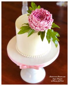 a white cake with pink flowers on top