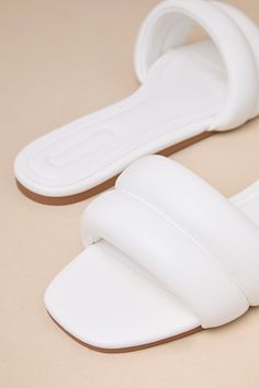 From running errands to poolside hangs, there's no better pick than the D'Amelio Footwear Kovella Bright White Faux Leather Flat Slide Sandals! Smooth faux leather shapes these trendy sandals with a square toe footbed and a wide vamp strap with a puffy, quilted-like effect. The easy slide-on design makes for effortless styling on the go! 0. 25" rubber heel. Cushioned insole. Rubber sole has nonskid markings. Man Made Materials. Imported. Lulus | Kovella Bright White Faux Leather Flat Slide Sanda Luxury Synthetic Sandals For Summer, Leather Slide Sandals With Padded Heel, Trendy White Leather Slides, Flat Sandals With Padded Heel For Beach, Leather Slides With Padded Heel For Summer, Luxury Synthetic Sandals For Vacation, Chic Flat Sandals With Padded Heel, Luxury Synthetic Sandals For The Beach, Luxury Synthetic Beach Sandals