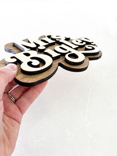 a hand holding a piece of wood that has the words'happy birthday'on it