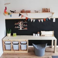 a playroom with toys and other items on the wall, including storage bins