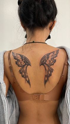 a woman with a tattoo on her back