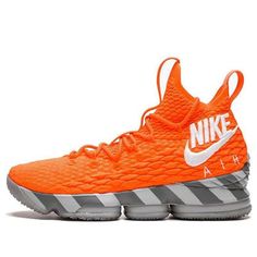 an orange nike basketball shoe with grey and white stripes on the upper half of it