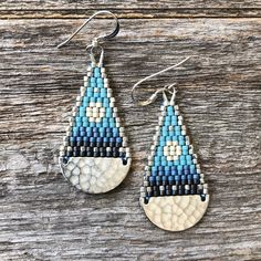 "These brick stitch and brass beaded earrings were handwoven with size 11/0 Miyuki delica glass seed beads. A time intensive and intricate craft, each bead is carefully hand stitched in order to create an even, uniform weave. The process requires focus, patience and dedication, as even a small pair of woven bead earrings can take hours to complete. Handwoven Brick Stitch Beadwork Miyuki delica glass seed beads  Sterling silver ear wires and findings silver plated brass components Extra durable nylon beading thread Each bead is approx. 1.6mm x 1.3mm Size: 2\" long (including ear wire) and 3/4\" wide Weight: 2g each (4g/pair)" Handmade Blue Heishi Beads Earrings, Silver Teardrop Beaded Earrings, Artisan Blue Beaded Earrings With Tiny Beads, Brass Components, Beading Thread, Star Light, Earring Ideas, Silver Moon, Glass Seed Beads