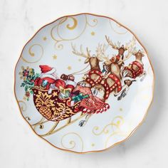 a plate decorated with santa's sleigh and reindeers