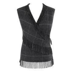 ALEXANDER McQUEEN F/W 1999 Gray Wool Plaid Wrap Fringe Sleeveless Vest Knit Top Brand / Manufacturer: Alexander McQueen Collection: F/W 1999 "The Overlook" Designer: Alexander McQueen Style: Sleeveless Sweater Top Color(s): Shades of gray, white, black Lined: Yes Marked Fabric Content: "100% wool" (primary material) Unmarked Fabric Content (feel of): Satin (lining) Additional Details / Inclusions: Alexander McQueen F/W 1999 "The Overlook" gray sleeveless sweater top. Flowy material; little to no Elegant Sleeveless Wool Top, Sleeveless Wool Winter Top, Wool Sleeveless Top For Winter, Sleeveless Wool Top For Winter, Fitted Sleeveless Wool Top, Fall Sleeveless Wool Top, Sleeveless Wool Top For Fall, Alexander Mcqueen Collection, Vest Knit