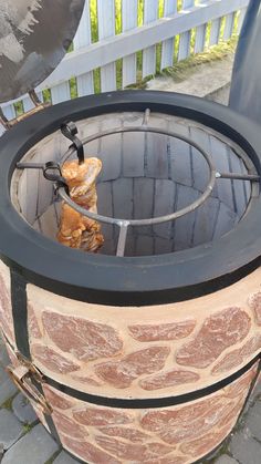 an outdoor fire pit with bread on it