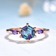 an engagement ring with blue and purple stones