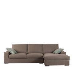 a sectional couch with pillows on it