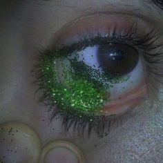 an eye with green glitter on it