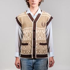 Prepare for autumn with our Star Wars Sweater Vests. Ideal for transitioning into colder temperatures, these vests embody style and class. Choose the perfect vest to showcase your loyalty to the dark side or your alliance to the Rebels. Jacquard double knit rib sweater vest Embroidered icon on the front chest Embroidered Aurebesh on the back Sweater Knit - 45% Acrylic, 30% Nylon, 25% Polyester Front pockets Imported Officially licensed Star Wars merchandise Mens Resort Wear, Star Wars Sweater, Marvel Hoodies, Varsity Cardigan, Rib Sweater, Flex Fit Hats, Star Wars Tees, Sweater Vests, Mens Long Sleeve Tee