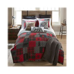 a bed with red and black plaid comforter set