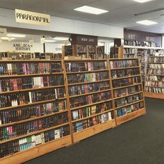 rows of books on wooden shelves in a library