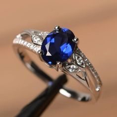 a ring with a blue stone and white diamonds