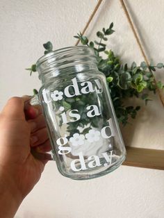 a hand holding a mason jar with the words today is a good day on it