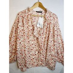 This Zara Blouse Is A Perfect Addition To Any Wardrobe. With A Beautiful Floral Pattern And Cute Ruffle Cuffs, It Is Sure To Catch The Eye. The Top Is Brand New With Tags And Comes In A Size X-Large. It Is A Relax-Wide Fit And Has A Floral Peach And Red Design That Will Match With A Variety Of Outfits. New Zara Paisley * Protection Of Old-Growth Forest* Reducton Of Water And Energy* Reduction Of Emissionscondition : New With Tag * Size : Xl * Pit To Pit : 58 Inches - Laying Flat * Pit To Cuff: 1 Chic Zara Blouse With Floral Print, Zara Printed Blouse For Fall, Zara Printed Blouse For Day Out, Feminine Zara Blouse For Fall, Zara V-neck Printed Blouse, Zara Printed V-neck Blouse, Zara Floral Print Blouse For Brunch, Zara Feminine Floral Print Tops, Feminine Zara Tops With Floral Print