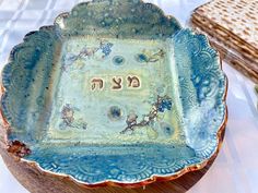 a blue dish with writing on it sitting on a table