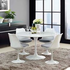 a white table with four chairs around it