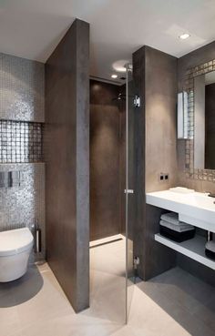 a modern bathroom with gray walls and flooring