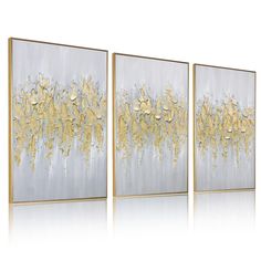 three gold and silver paintings on a white background