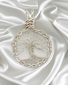 This Tree of Life pendant was artistically crafted using sterling silver wire. The trunk of the tree is anchored to a circular frame created from twisted sterling silver wire that was hammered flat. The pendant measure 1 3/8" wide and 1 3/4" long from the top of the bail to the roots of the tree. It is suspended from your choice of a 16" or 18" sterling silver diamond cut bead chain with lobster claw clasp. Just choose the one you want in the pull down menu when ordering. The Tree of Life is a u Bohemian Silver Jewelry With Tree Of Life, Unique Tree Of Life Round Jewelry, Silver Wire Wrapped Nature-inspired Jewelry, Silver Wire Wrapped Round Pendant Jewelry, Artistic Sterling Silver Wire Wrapped Jewelry, Silver Wire Wrapped Jewelry With Round Pendant, Silver Nature-inspired Wire Wrapped Jewelry, Artistic Silver Wire Wrapped Necklaces, Artistic Silver Wire Wrapped Necklace