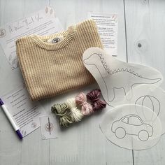 some crafting supplies are laid out on a table with paper and scissors to make it look like dinosaurs