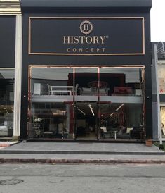 a store front with the words history written on it's side and an empty street in front