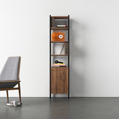 a chair sitting in front of a book shelf