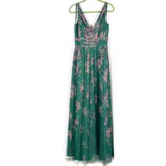 a green dress hanging on a hanger