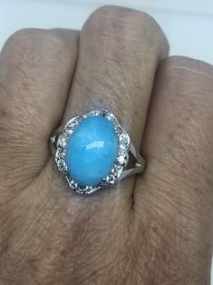 Large genuine aqua blue Larimar Vintage ring Low content silver not sterling. Size 9 My jeweler can re size it for a $10-$20 fee All rings are shipped in a nice gift box. Check out our over a THOUSAND great reviews Engraving is $4 per letter and is not always perfect depending on the piece. It can take a few days if the jeweler is busy. This is payable to Paypal Judithsltd@gmail.com Fine Jewelry Blue Turquoise Ring For Anniversary, Elegant Blue Larimar Turquoise Ring, Blue Turquoise Ring With Center Stone, Elegant Blue Larimar Rings, Formal Blue Turquoise Ring With Accent Stones, Light Blue Ring For Anniversary, Silver Larimar Turquoise Ring For Anniversary, Silver Turquoise Larimar Ring For Anniversary, Collectible Round Turquoise Ring