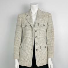 Beautiful Plaid Blazer by Escada in grey and cream tones with 4 functional pockets in the front . Buttoned cuffs and fully lined. It's is 80% wool and 20% pa-nylon but the fabric has a soft almost fuzzy textured to it .  It's in great  condition with no holes or stains. Size 36 euro on label fits like a US 2-4 - please verify with measurements below to ensure correct fit.  Shoulder to shoulder approx 15.5" Pit to pit approx 17" Waist approx 15.5" Length from shoulder to seam 27" Sleeve length 21 Classic White Wool Tweed Jacket, Cream Wool Outerwear With Pockets, White Tweed Jacket With Pockets For Work, Classic Cream Outerwear With Flap Pockets, Classic Cream Blazer With Pockets, Classic Cream Blazer, Classic Cream Wool Tweed Jacket, Beige Tweed Jacket With Pockets For Business Casual, Classic Cream Tweed Jacket For Fall