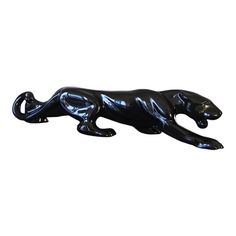 a black cat figurine on a white background