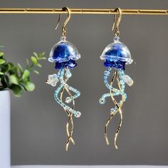 Our cute colorful jellyfish earrings are made with transparent glass shell, high quality Japanese glass beads and 14K gold plated hooks are comfortable for delicate ears. since each jellyfish is handmade, each one will have a unique look. Size: approx. 1" wide and 3.75" long 🌺 The jellyfishes are made with glass, please handle with care. Jelly Fish Inspired Garments, Jellyfish Earrings Diy, Aquatic Earrings, Bead Jellyfish, Aquatic Jewelry, Jellyfish Transparent, Beaded Jellyfish, Deep Sea Jellyfish, Beach Wedding Theme