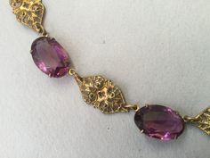 "Czech oval amethyst glass bezel/prong set cabochon collar. Wonderful Art Deco necklace that could have been made in the 20's or 30s. This is most likely made in the 1930s. Unusual bezels capture the colored glass gems that are in tandem with gilt brass filigree planks. Truly appealing necklace. This could be the antique necklace for you. Lovely condition but does show some slight greening on a couple of the gilt filigree pieces. Please look carefully. One of my favorites! 14 1/2\" long Glass an Formal Amethyst Oval Cabochon Jewelry, Formal Amethyst Jewelry, Oval Cabochon, Formal Purple Oval Cabochon Jewelry, Victorian Oval Jewelry For Evening, Classic Oval Necklaces For Evening, Oval Filigree Necklaces For Formal Occasions, Formal Oval Filigree Necklace, Ornate Oval Pendant Necklaces For Formal Occasions, Vintage Gemstone Necklace With Oval Cabochon