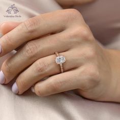 a woman's hand with a diamond ring on it