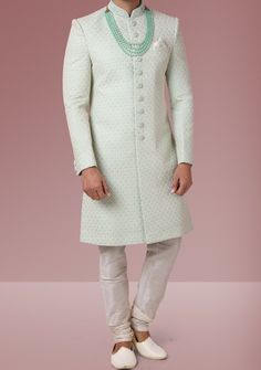 Ready-Made Sherwani With Trouser. Jacquard Brocade Fabric Top. Art Dupion Aligarhi Ready Made Trouser. Crafted in Chinese Collar Neck, and Full Sleeve. Satin Lining with Plain Work. High-Quality Matching Buttons. Please Note: The footwear shown in the picture is for presentation and photography purpose only. Color: There might be slight color variation due to lightings and flashes while photo shooting. The color may also vary because of different screen resolutions. Wash Care: Dry Clean Only. Ceremonial Pista Green Kurta With Zari Work, Ceremonial Pista Green Kurta With Pallu, Pista Green Ceremonial Kurta For Diwali, Pista Green Kurta For Diwali, Long Sets With Chikankari Embroidery For Reception, Traditional Green Unstitched Suit For Reception, Formal Green Churidar With Dabka Detailing, Formal Green Traditional Wear With Chikankari Embroidery, Designer Sherwani With Straight Kurta For Reception