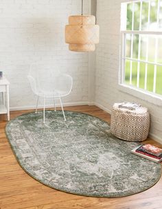 a white chair sitting on top of a wooden floor next to a green area rug