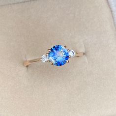 a blue ring with three diamonds on it