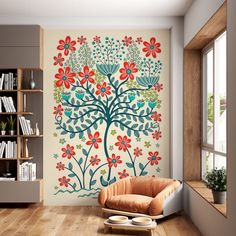 a living room with a large tree painted on the wall next to a chair and bookshelf