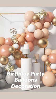 an assortment of balloons and cake stands in front of a white wall with gold accents