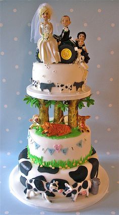 a three tiered wedding cake decorated with farm animals and bride and groom figurines