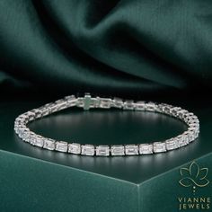 Experience the epitome of elegance with our luxurious 7.35 TCW Emerald Cut Lab-Grown Diamond Bracelet. Each diamond, meticulously crafted with precision, showcases the brilliance and clarity that rivals natural stones. Ethically sourced and environmentally conscious, our lab-grown diamonds offer a modern and sustainable choice for the discerning jewelry aficionado. This bracelet is not just a piece of jewelry; it's a statement of sophistication and contemporary luxury. Perfect for special occasions or to elevate any outfit, its timeless design ensures it will be cherished for generations to come. 💎 BRACELET Features: → Shape: EMERALD CUT → Carat: 7.35 TCW → Color: G+ → Clarity: VS+ As the listed ring is a custom order, there may be slight variations in its measurements or carat weight due Diamond Bracelet For Women, Emerald Cut Moissanite, Diamond Tennis Bracelet, Wedding Jewelry Bracelets, Contemporary Luxury, 19 Days, Platinum Metal, Environmentally Conscious, Tennis Bracelet Diamond