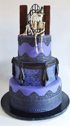 a purple and black cake with a skeleton sitting on it's top tiers