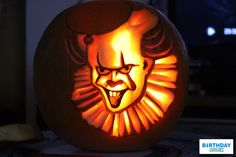 a pumpkin carved to look like it has a creepy face on it and is lit up