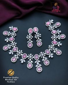 Elevate your elegance with this premium quality Silver/Rhodium finish AD necklace set, featuring stunning pink gemstones. The intricate design showcases a harmonious blend of pear and marquise-shaped stones, complemented by dazzling American diamonds. This set includes a matching pair of earrings, making it perfect for special occasions, weddings, or festive celebrations. The combination of the lustrous rhodium finish and vibrant pink stones adds a touch of sophistication and glamour to any outf Elegant Pink Hand Set Jewelry Sets, Pink Hand Set Round Jewelry Sets, Pink Cubic Zirconia Bridal Necklace For Party, Formal Pink Cubic Zirconia Bridal Necklace, Elegant Pink Cubic Zirconia Bridal Necklace, Formal Pink Bridal Necklace, Hand Set Pink Bridal Necklace, Pink Cubic Zirconia Bridal Necklace For Anniversary, Pink Round Cubic Zirconia Bridal Necklace