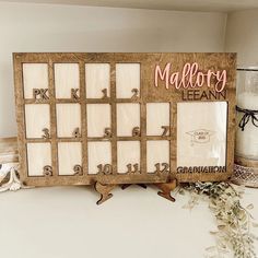 a wooden calendar frame sitting on top of a table