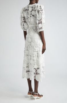 Crafted from delicately layered guipure lace with three-dimensional appliqués, this elegant dress is designed with sheer puff sleeves and cinched with a belt. Hidden back-zip closure Jewel neck Three-quarter sleeves with elastic cuffs Removable belt Slip lining 100% polyester Dry clean Imported Designer Clothing Lace Patchwork Puff Sleeve Dress, Lace Dress With Puff Sleeves And Lace Patchwork, White Lace Puff Sleeve Dress For Spring, Elegant Lace Puff Sleeve Dress With Short Sleeves, Short Sleeve Lace Dress With Sheer Sleeves, Lace Puff Sleeve Dress For Garden Party, Lace Dress With Puff Sleeves For Garden Party, Elegant Short Sleeve Lace Puff Sleeve Dress, Midi Lace Dress With Sheer Sleeves