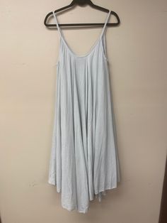 This Italian-made A-line dress is your perfect summer wardrobe piece! Light and airy in 100% cotton, it's comfy enough for a day of lounging with friends, but jazz it up with some accessories and you'll be ready for a night of fun. With a V-neck front and back, plus spaghetti straps, you'll look totally fab - no matter how you wear it! Summer Flowy Gray Dresses, Gray Flowy Summer Dresses, Flowy Gray Summer Dresses, Summer Sundress For Loungewear, Summer Loungewear Dresses, Flowy A-line Cotton Sundress, Flowy Casual Sundress For Loungewear, Spring Cotton Dresses For Lounging, Cotton Lounge Dress For Spring